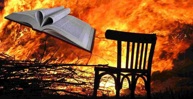 Bible and chair in front of fire