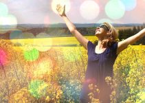 Woman in field raising hands connected with God