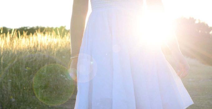 Little Girl in White Dress Facing Light