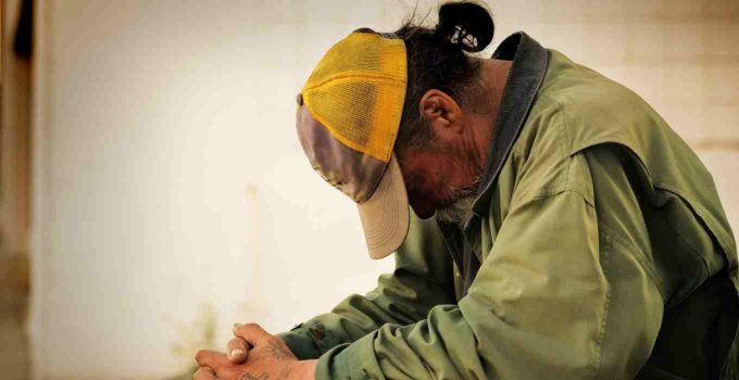 Homeless man praying