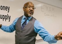 African professor teaching on money supply