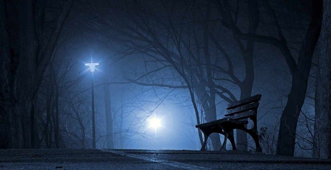 A lonely park bench in night fog