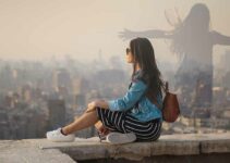 Girl overlooking city, thinking, silhouette.