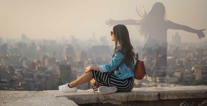 Girl overlooking city, thinking, silhouette.
